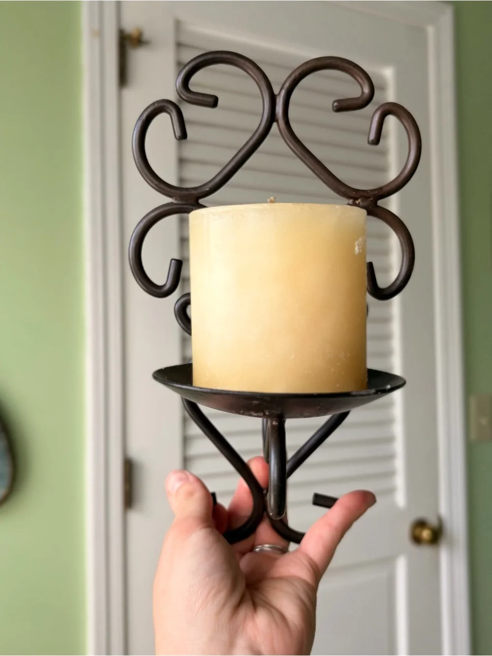 Vintage Metal Scroll Wall Candle Sconce with Cream Pillar Candle